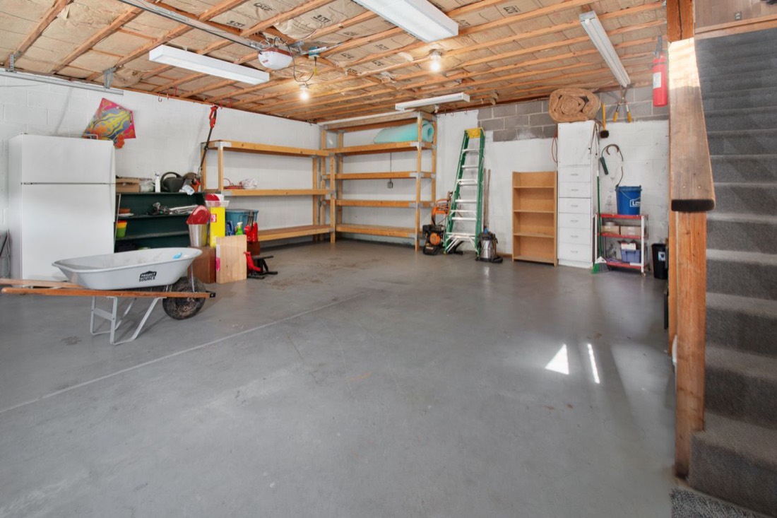 Residential garage with a plain, uncoated gray concrete floor
